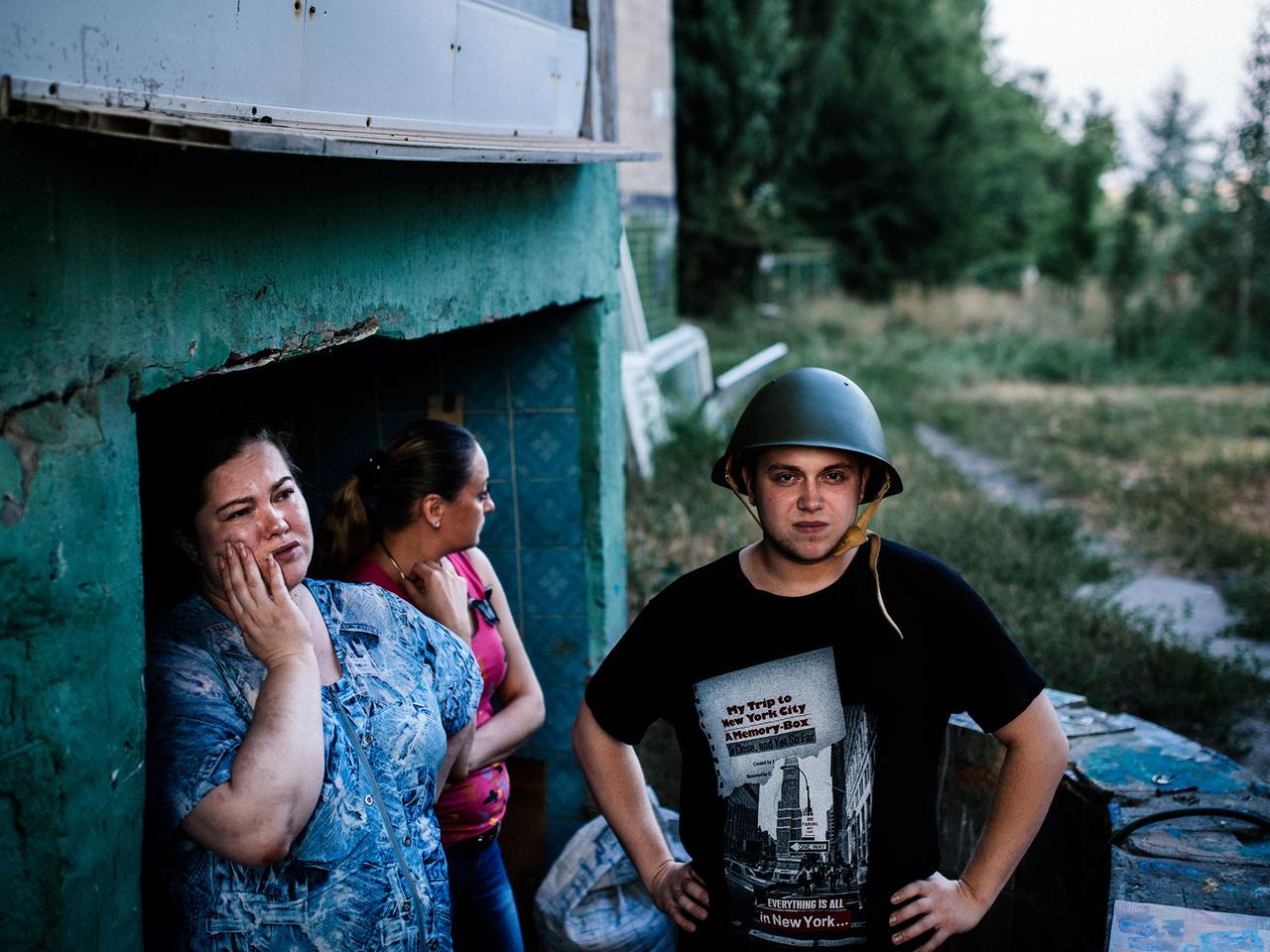In der ostukrainischen Metropole Donezk stehen Einwohner am Zugang zu einem provisorischen Luftschutzbunker.