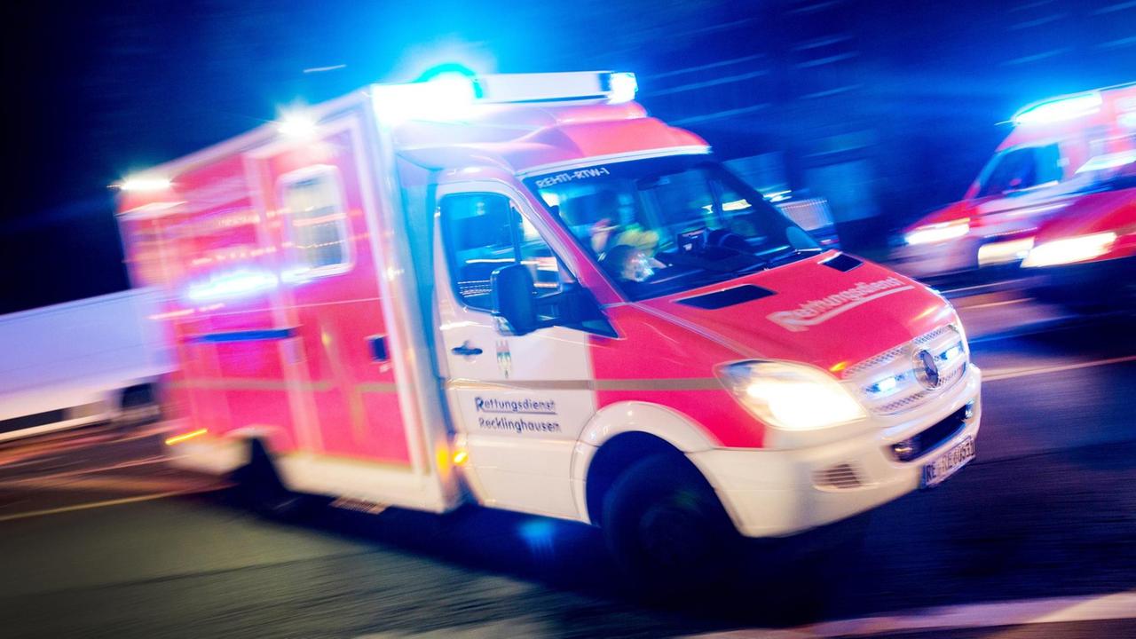 Ein Rettungswagen mit Blaulicht in schneller Fahrt Ein Rettungswagen mit Blaulicht in schneller Fahrt