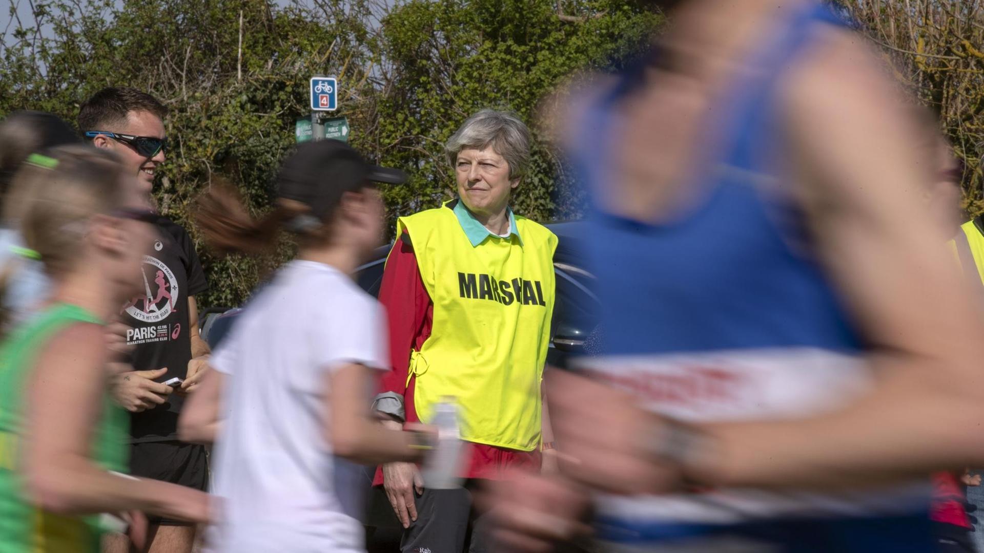 Theresa May at the Maidenhead Easter 10. Prime Minister Theresa May acts as a marshal during the Maidenhead Easter 10 race in maidenhead. Picture date: Friday April 19, 2019. Photo credit should read: Steve Parsons/PA Wire URN:42407796 | Theresa May at the Maidenhead Easter 10. Prime Minister Theresa May acts as a marshal during the Maidenhead Easter 10 race in maidenhead. Picture date: Friday April 19, 2019. Photo credit should read: Steve Parsons/PA Wire URN:42407796 |