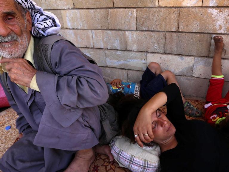 Irakische Christen ruhen sich nach ihrer Flucht aus der von IS-Terrormilizionären eroberten Stadt Karakosch im kurdischen Arbil aus.