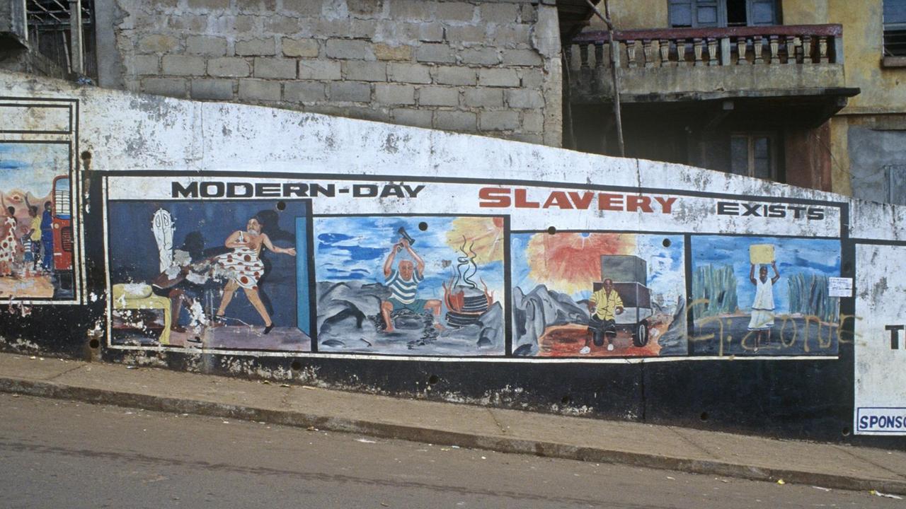Das Foto aus Freetown, der Hauptstadt von Sierra Leone zeigt eine Mauer mit Straßenmalerei und der Überschrift "modern slavery exist." Das Foto aus Freetown, der Hauptstadt von Sierra Leone zeigt eine Mauer mit Straßenmalerei und der Überschrift "modern slavery exist."