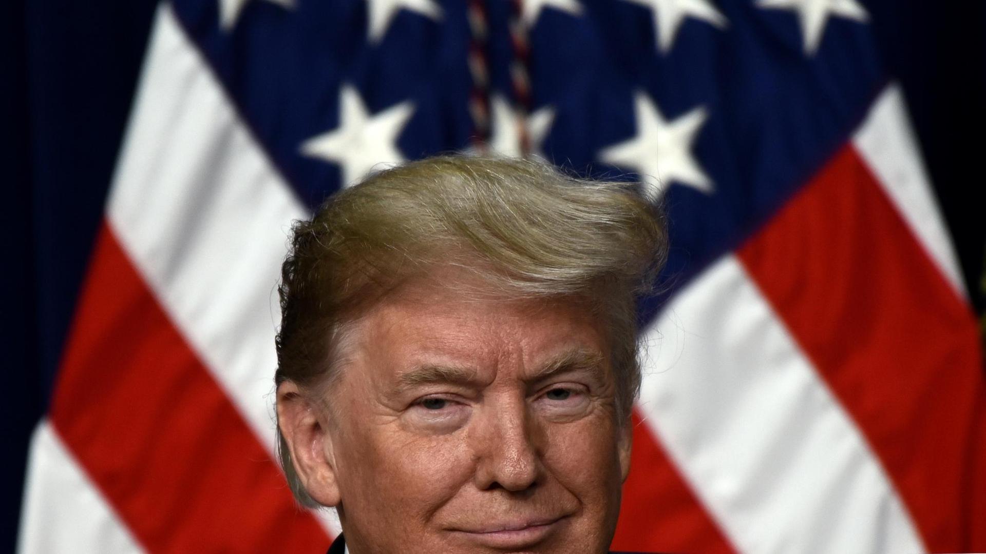 US-Präsident Donald Trump vor einer US-amerikanischen Flagge US-Präsident Donald Trump vor einer US-amerikanischen Flagge