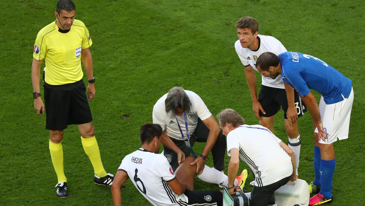 Sami Khedira liegt auf dem Boden und lässt sich sein Bein untersuchen. Sami Khedira liegt auf dem Boden und lässt sich sein Bein untersuchen.