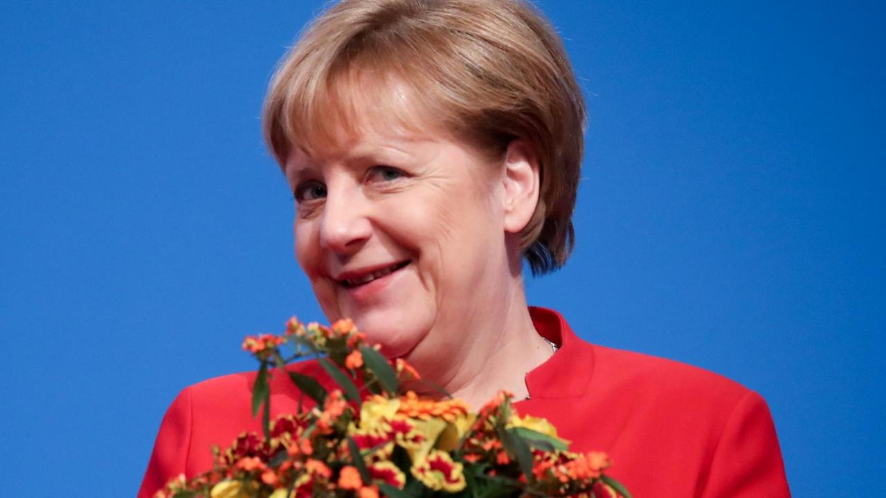 Bundeskanzlerin Merkel erhält nach ihrer Wiederwahl zur CDU-Vorsitzenden einen Blumenstrauß