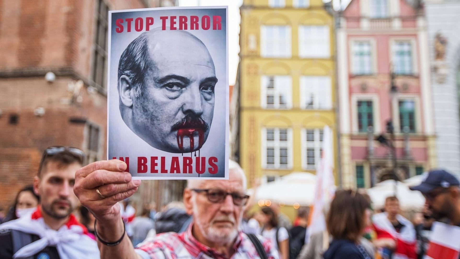 "Solidarity with Belarus March" in Gdansk. Ein Mann hält ein "Stop Terror in Belarus" Schild in die Höhe, 2021. "Solidarity with Belarus March" in Gdansk. Ein Mann hält ein "Stop Terror in Belarus" Schild in die Höhe, 2021.