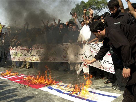 Pakistanische Schiiten verbrennen eine USA-Flagge, eine dänische und eine israelische Fahne.