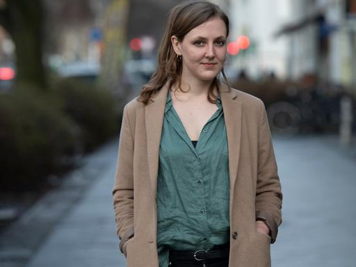 Die Autorin und freie Journalistin Valerie Schönian steht in Berlin an einer Straße.
