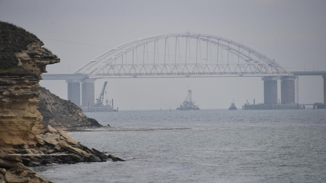 Ein Schiff fährt unter der Brücke über die Meerenge von Kertsch. Ein Schiff fährt unter der Brücke über die Meerenge von Kertsch.