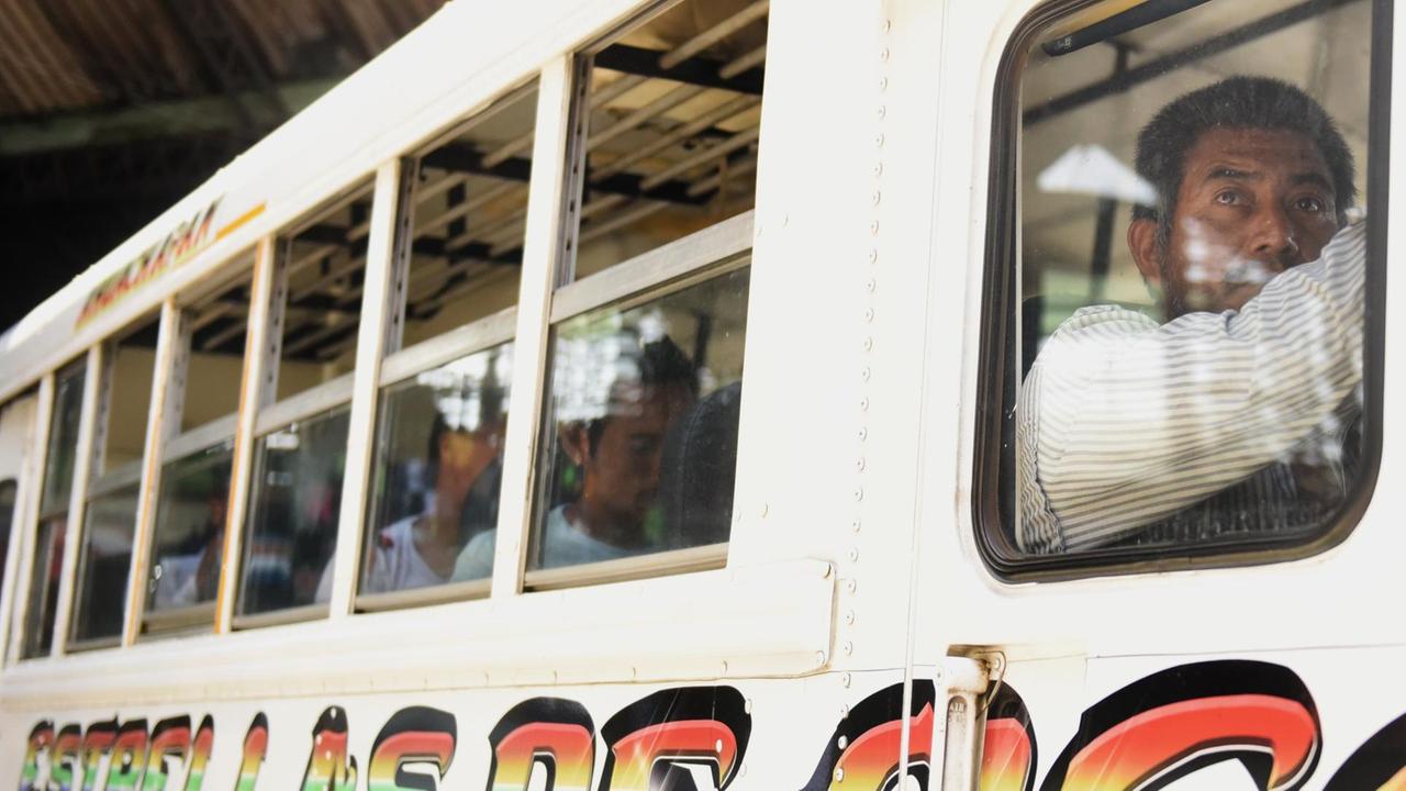 Fahrgäste werden durch Bandenmitglieder in einem Bus an einer Haltestelle in San Salvador/El Salvador festgehalten, die versuchen, verhaftete Genossen freizupressen. 31.07.2015 - AFP Marvin Recinos Fahrgäste werden durch Bandenmitglieder in einem Bus an einer Haltestelle in San Salvador/El Salvador festgehalten, die versuchen, verhaftete Genossen freizupressen. 31.07.2015 - AFP Marvin Recinos