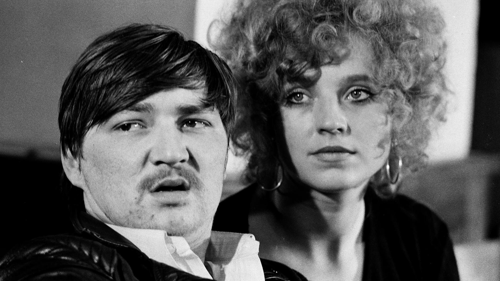 Ausschnitt aus dem Film "Baal" von Bertolt Brecht, verfilmt von Volker Schlöndorff 1969. Zu sehen sind im schwarzweiß Portrait zwei Personen, Rainer Werner Fassbinder und Hanna Schygulla, die an der Kamera vorbei schauen. Ausschnitt aus dem Film "Baal" von Bertolt Brecht, verfilmt von Volker Schlöndorff 1969. Zu sehen sind im schwarzweiß Portrait zwei Personen, Rainer Werner Fassbinder und Hanna Schygulla, die an der Kamera vorbei schauen.