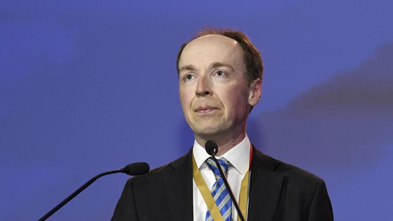 Finnish politician and member of the European Parliament Jussi Halla-aho, center, delivers a speech after he was elected to be the new chairman for the Finns Party at the party's congress in Jyvaskyla, Finland