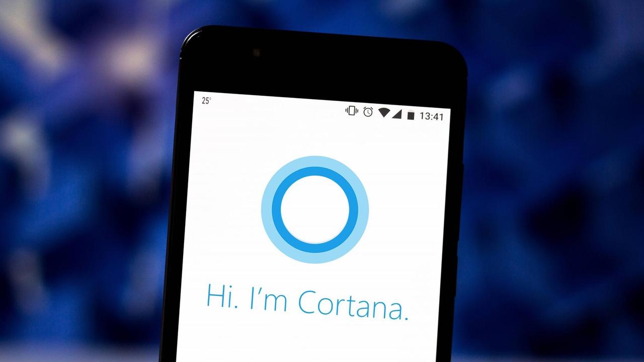 Ein Handybildschirm mit einem blauen Kreis darauf und dem Schriftzug "Hi. I’m Cortana." Ein Handybildschirm mit einem blauen Kreis darauf und dem Schriftzug "Hi. I’m Cortana."