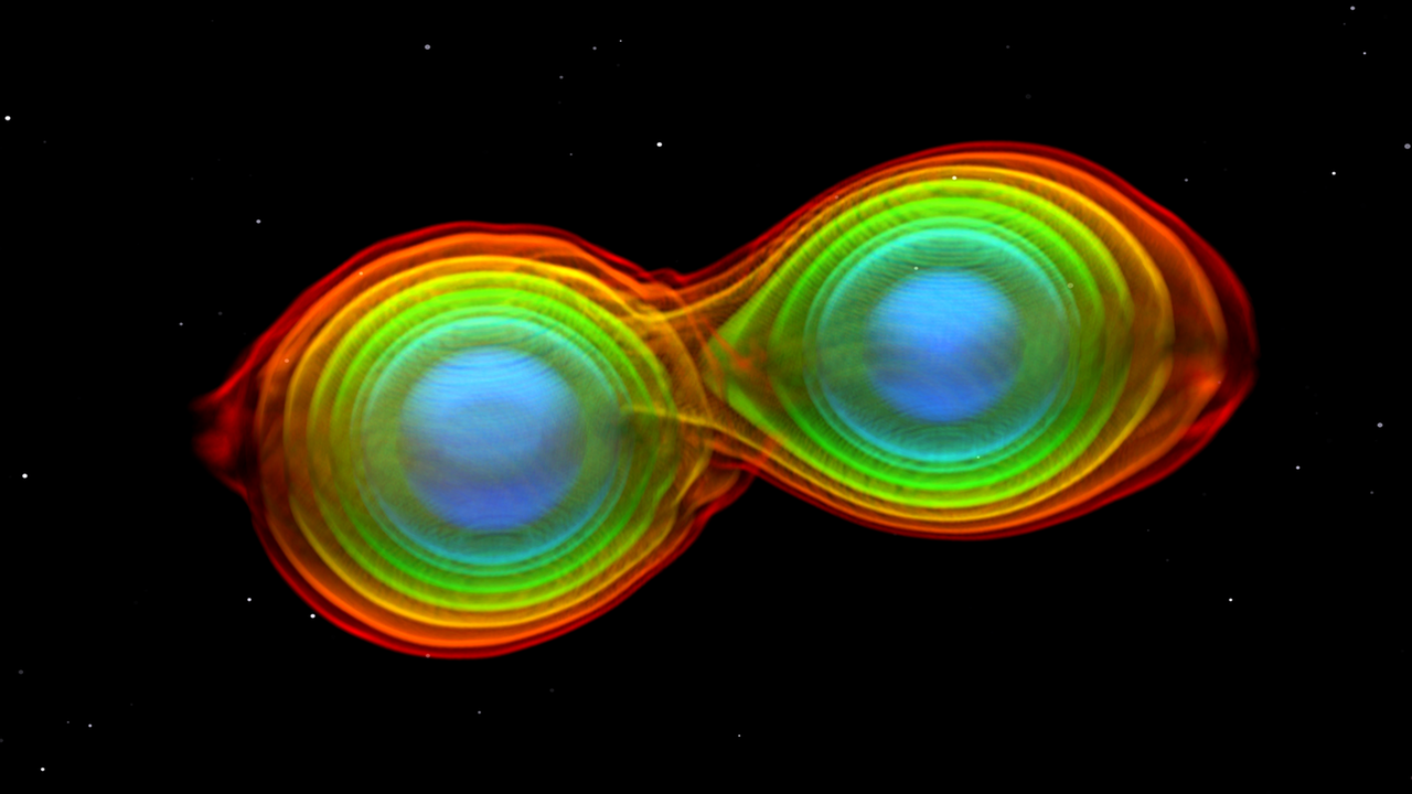 Numerisch-relativistische Simulation zweier einander umkreisender und verschmelzender Neutronensterne. Ein solches Ereignis wurde am 17. August 2017 erstmalig durch das LIGO-Virgo-Detektornetzwerk beobachtet und führte zum gemessenen Gravitationswellensignal GW170817 und zum Gammastrahlenausbruch GRB170817A. Numerisch-relativistische Simulation zweier einander umkreisender und verschmelzender Neutronensterne. Ein solches Ereignis wurde am 17. August 2017 erstmalig durch das LIGO-Virgo-Detektornetzwerk beobachtet und führte zum gemessenen Gravitationswellensignal GW170817 und zum Gammastrahlenausbruch GRB170817A.