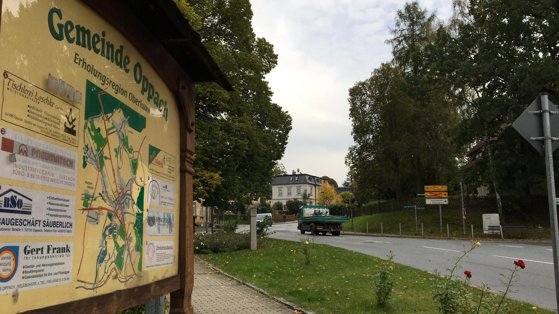 Ein Schild mit Wegen zum Wandern in und um Oppach steht an einer Straße in der Stadt. Ein Schild mit Wegen zum Wandern in und um Oppach steht an einer Straße in der Stadt.