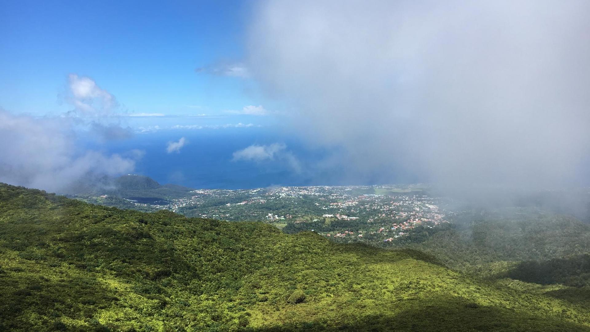 Blick von la Soufrière auf Guadeloupe durch Wolken.