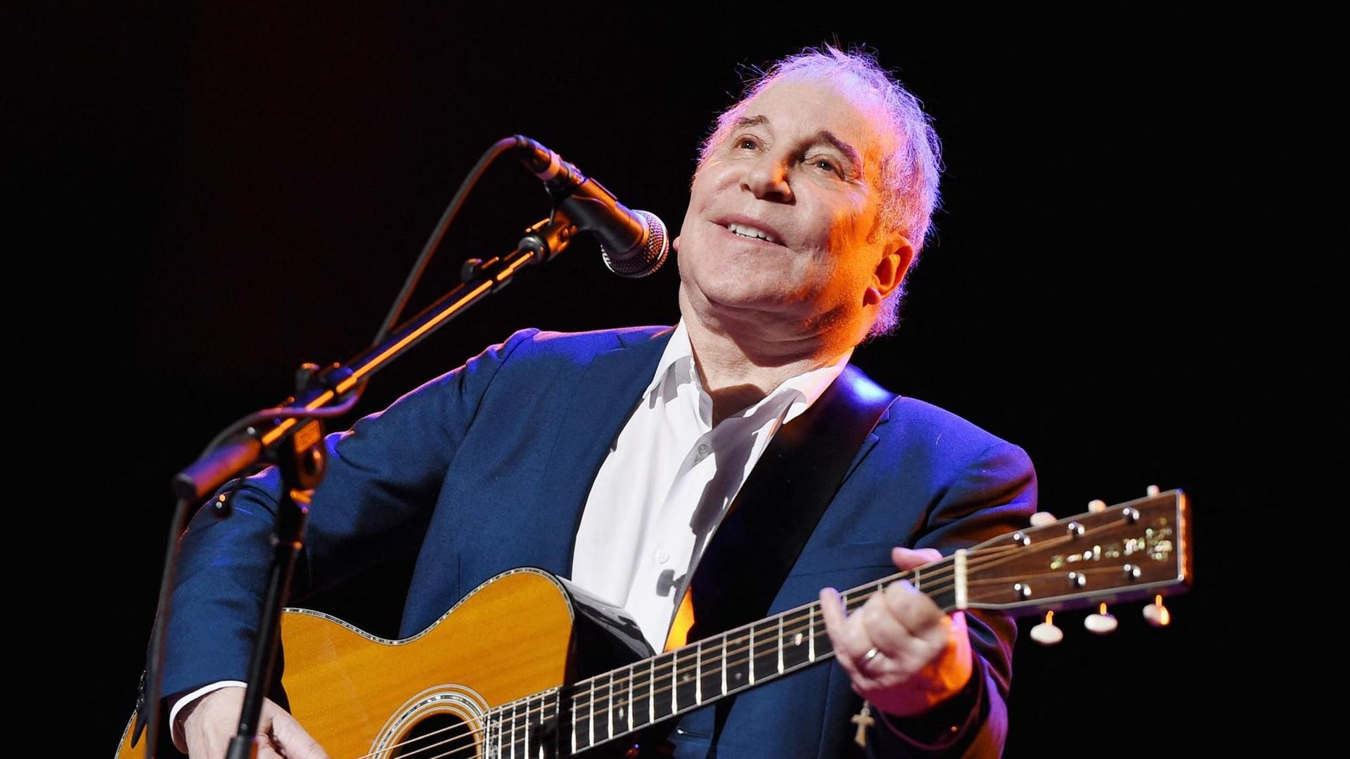Paul Simon mit Gitarre auf der Bühne, während des "Global Citizen: The World On Stage" Konzertes in New York City, 2016. Paul Simon mit Gitarre auf der Bühne, während des "Global Citizen: The World On Stage" Konzertes in New York City, 2016.