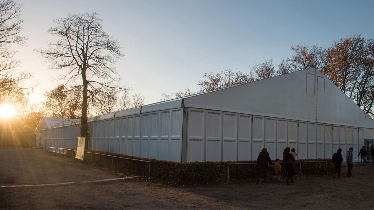 Flüchtlinge gehen in ein Zelt in der Flüchtlingsnotunterkunft im Stuttgarter Reitstadion Bad Cannstatt Flüchtlinge gehen in ein Zelt in der Flüchtlingsnotunterkunft im Stuttgarter Reitstadion Bad Cannstatt