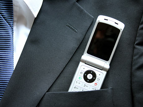 Ein Mobiltelefon steckt in einer Anzugjacke