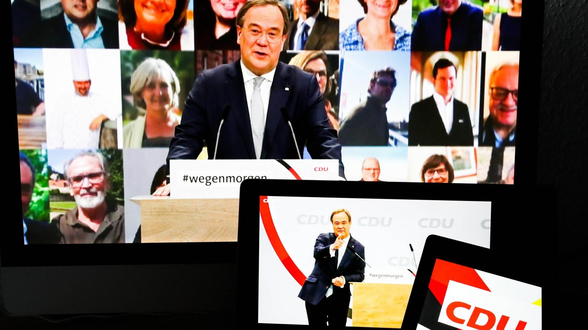Armin Laschet ist auf mehreren Bildschirmen auf dem digitalen Parteitag der CDU zu sehen. Armin Laschet ist auf mehreren Bildschirmen auf dem digitalen Parteitag der CDU zu sehen.