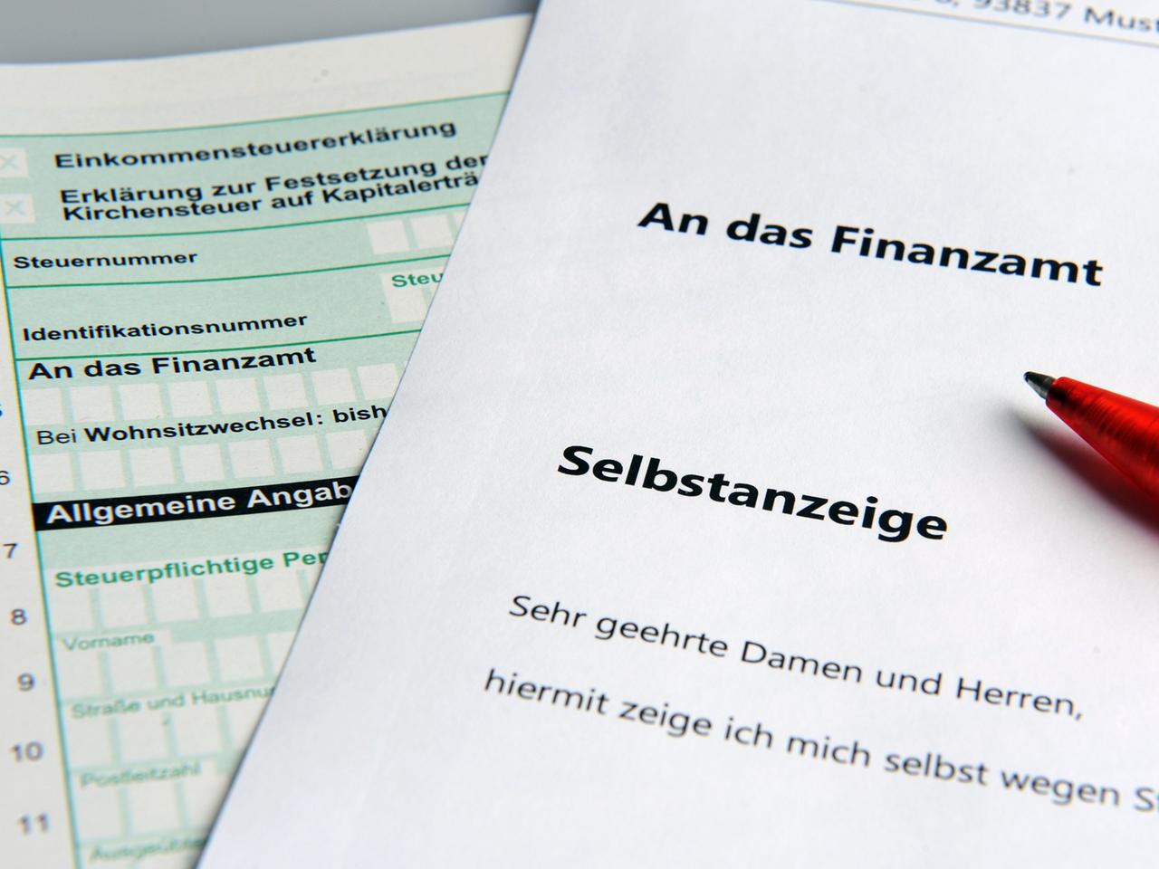 Im Bild ist links ein Steuererklärungsformular und darüber liegend rechts ein weißes Blatt mit dem Titel "Selbstanzeige" zu sehen. Im Bild ist links ein Steuererklärungsformular und darüber liegend rechts ein weißes Blatt mit dem Titel "Selbstanzeige" zu sehen.