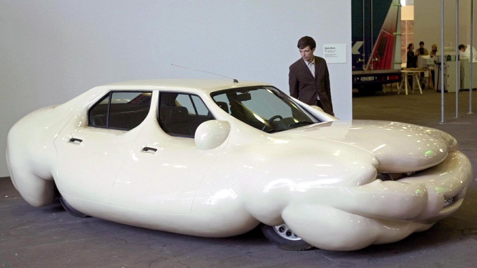 Ein Besucher der Kunstmesse «Art 32» in Basel schaut sich bei einer Vorbesichtigung am 12.6.2001 das "Fette Auto" des Künstlers Erwin Wurm an.