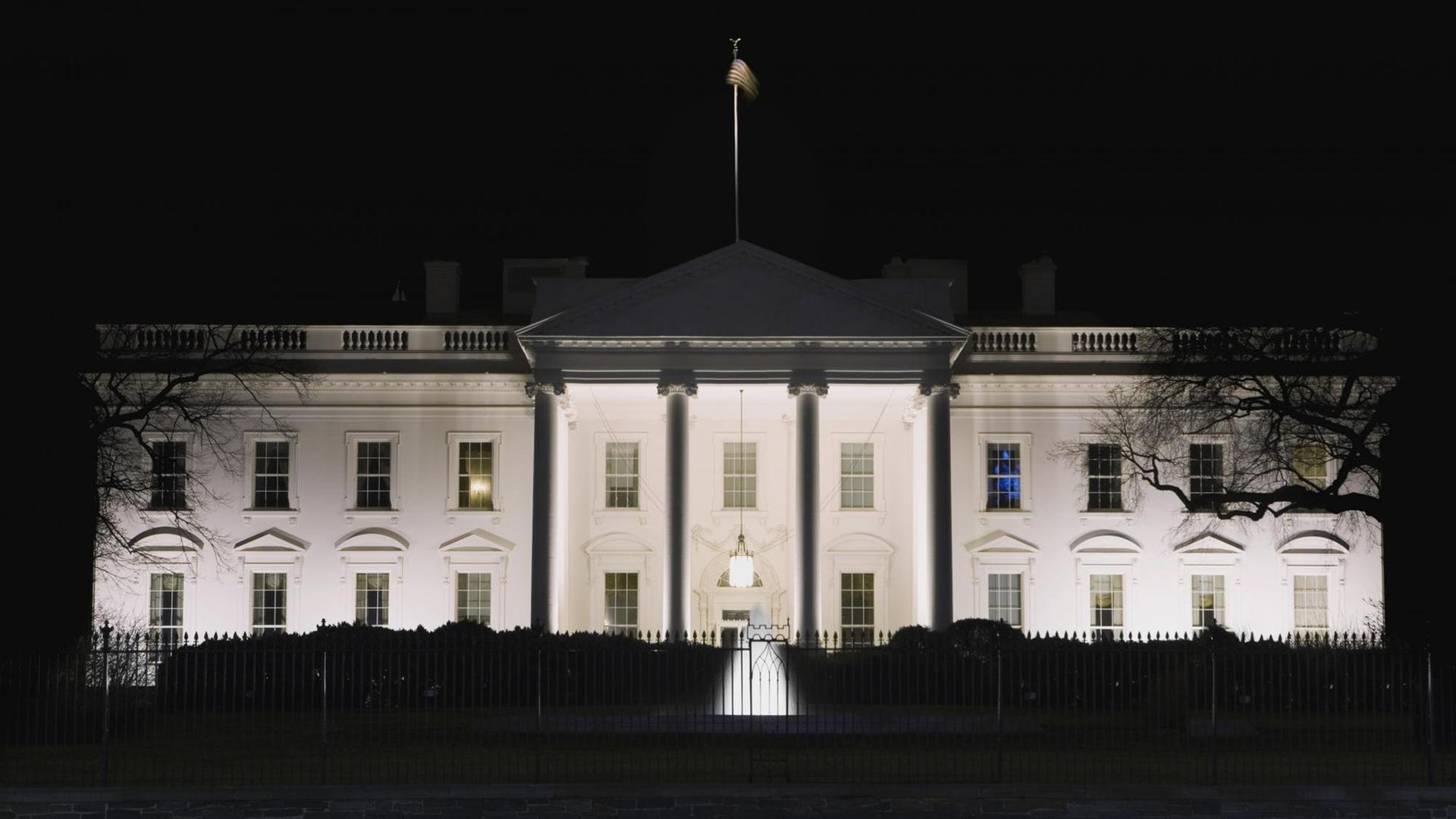 Das White House in Washington DC bei Nacht, in einem Fenster scheint Licht. Das White House in Washington DC bei Nacht, in einem Fenster scheint Licht.