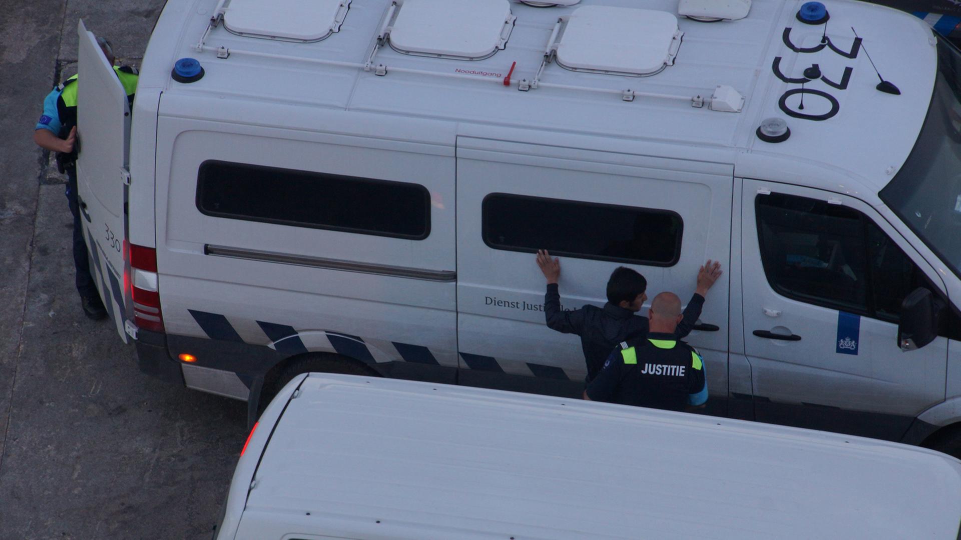 Frontex-Mitarbeiter nehmen einen Flüchtling fest. Frontex-Mitarbeiter nehmen einen Flüchtling fest.