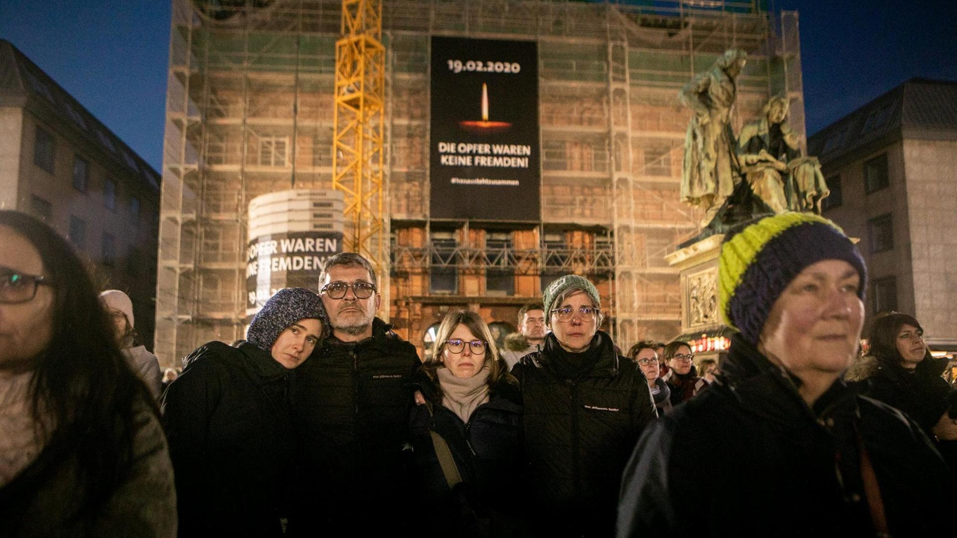 Hunderte von Menschen versammelten sich im Stadtzentrum von Hanau, um im März die Gedenkfeier auf Freiluft-Leinwänden zu verfolgen. Hunderte von Menschen versammelten sich im Stadtzentrum von Hanau, um im März die Gedenkfeier auf Freiluft-Leinwänden zu verfolgen.