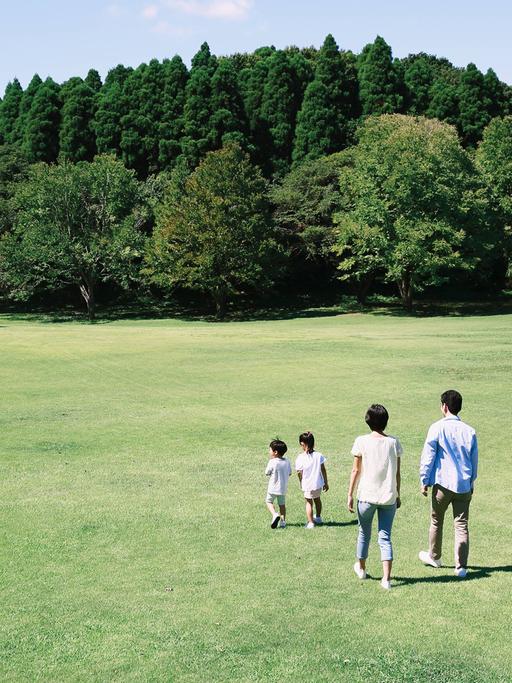 Glückliche japanische Familie in einem Park