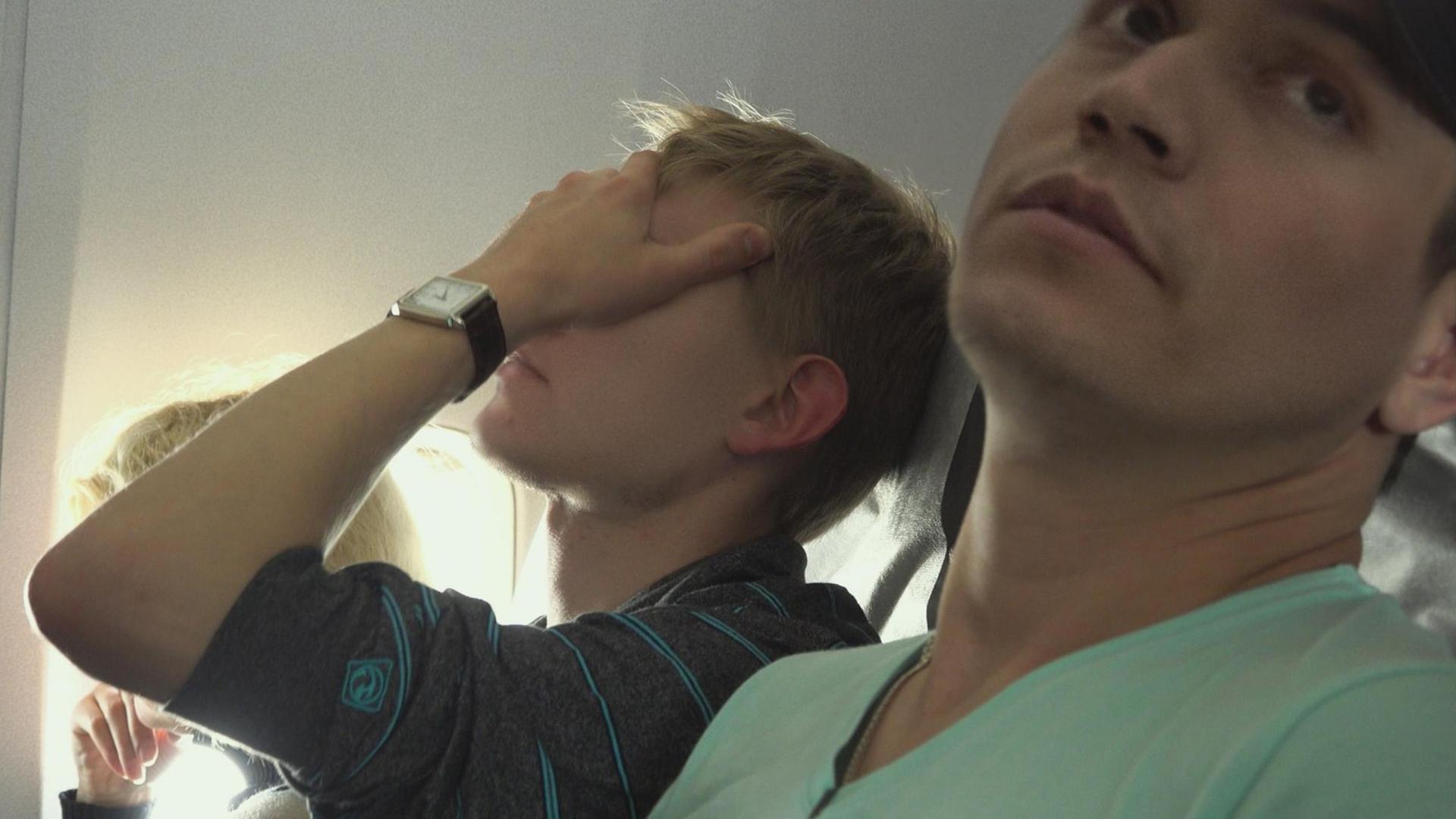 Film-Still aus "Welcome to Chechnya": Männer im Flugzeug. Film-Still aus "Welcome to Chechnya": Männer im Flugzeug.