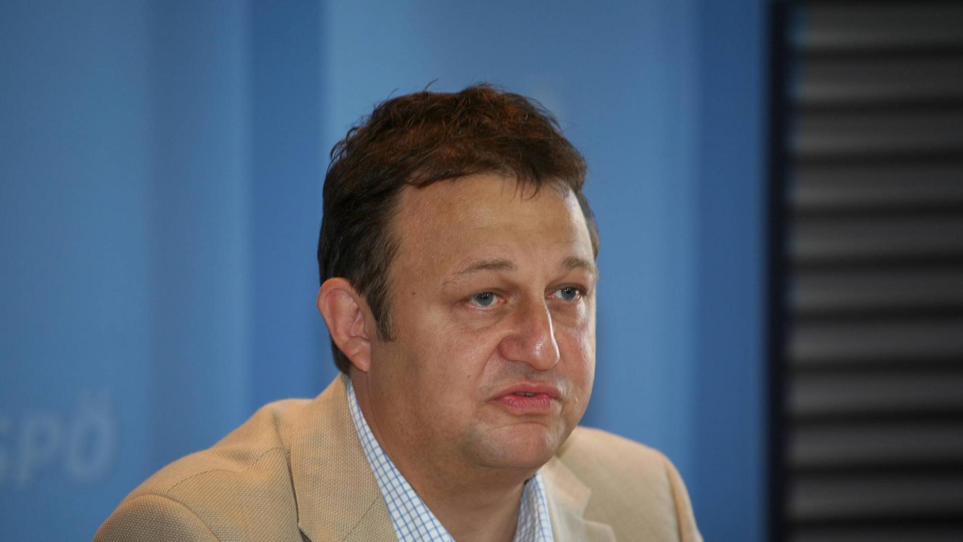 Kalina im beigen Jackett vor einem blauen Hintergrund. Kalina im beigen Jackett vor einem blauen Hintergrund.