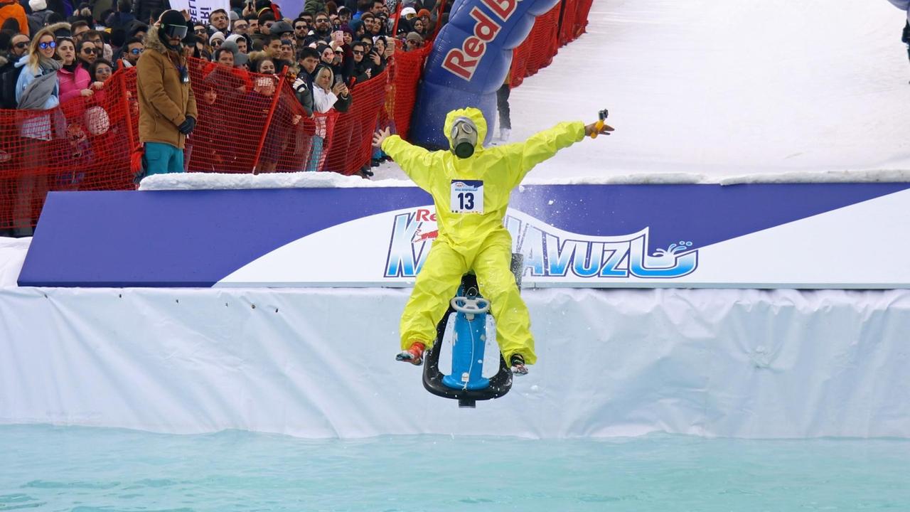 Ein Teilnehmer während eines Events in der Türkei landet mit einer Art Schlitten in einem eisgefrorenen Pool. Ein Teilnehmer während eines Events in der Türkei landet mit einer Art Schlitten in einem eisgefrorenen Pool.