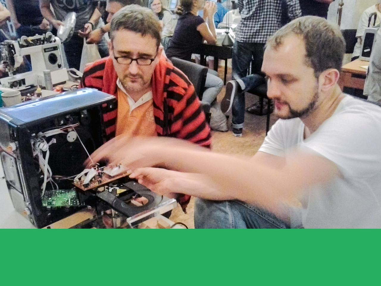 Zu sehen sind Studenten, die an Elektrogeräten herumbasteln, um sie wieder in Gang zu bringen. Zu sehen sind Studenten, die an Elektrogeräten herumbasteln, um sie wieder in Gang zu bringen.