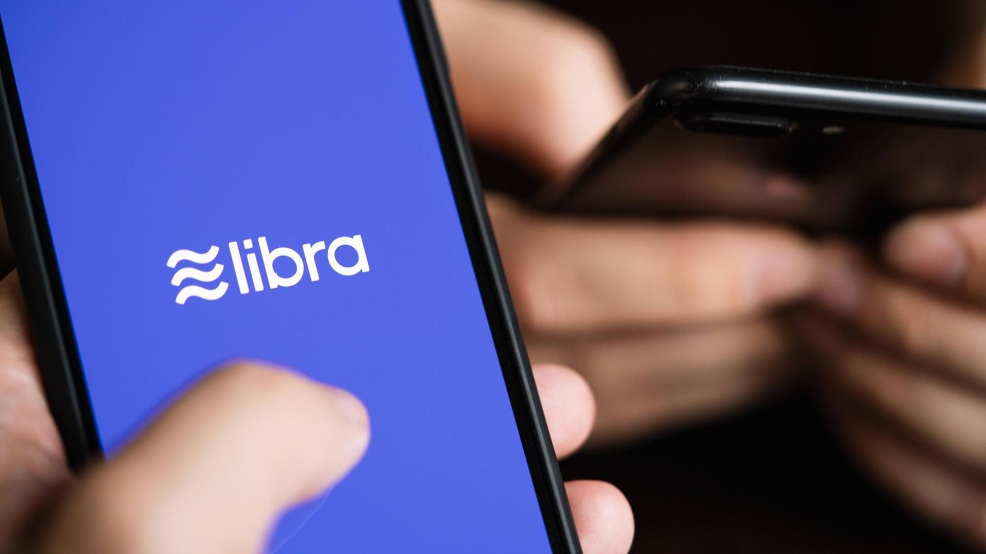Nahaufnahmen von zwei Smartphones. Auf einem ist das Logo von libra zu erkennen. Nahaufnahmen von zwei Smartphones. Auf einem ist das Logo von libra zu erkennen.