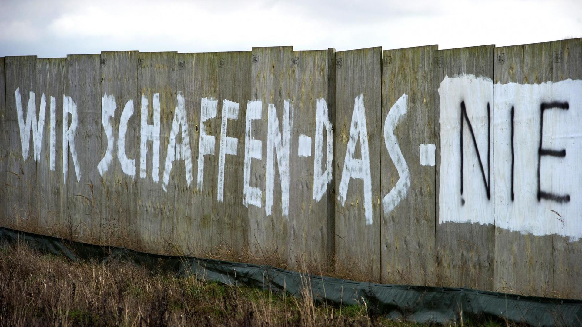 Der Schriftzug "Wir schaffen das nie" steht an einem Bauzaun der neuen Bundesstraße B96 bei Rambin (Mecklenburg-Vorpommern) auf der Insel Rügen, die zum Wahlkreis von Bundeskanzlerin Merkel gehört. Der Schriftzug "Wir schaffen das nie" steht an einem Bauzaun der neuen Bundesstraße B96 bei Rambin (Mecklenburg-Vorpommern) auf der Insel Rügen, die zum Wahlkreis von Bundeskanzlerin Merkel gehört.