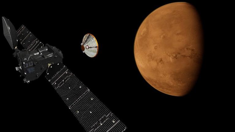 Der ExoMars Trace Gas Orbiter und die Landekapsel Schiaparelli beim Anflug auf Mars (Zeichnung). Der ExoMars Trace Gas Orbiter und die Landekapsel Schiaparelli beim Anflug auf Mars (Zeichnung).