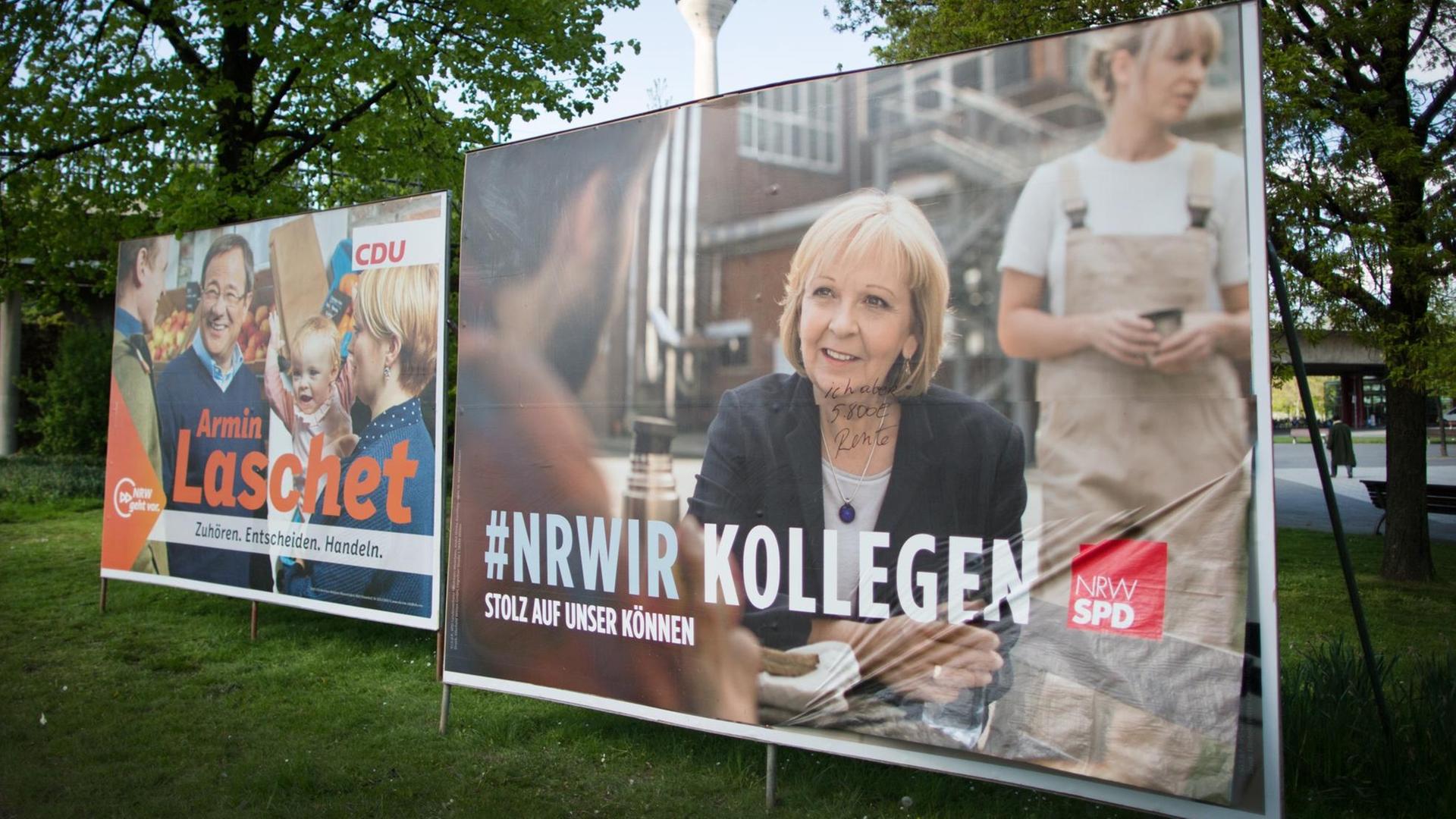 Wahlplakate der nordrhein-westfälischen Spitzenkandidaten in Düsseldorf. Links ein Plakat der CDU mit Laschet und rechts eines der SPD mit Kraft. Wahlplakate der nordrhein-westfälischen Spitzenkandidaten in Düsseldorf. Links ein Plakat der CDU mit Laschet und rechts eines der SPD mit Kraft.