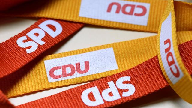 Symbolbild für die Große Koalition: Logos von CDU und SPD auf Schlüsselbändern