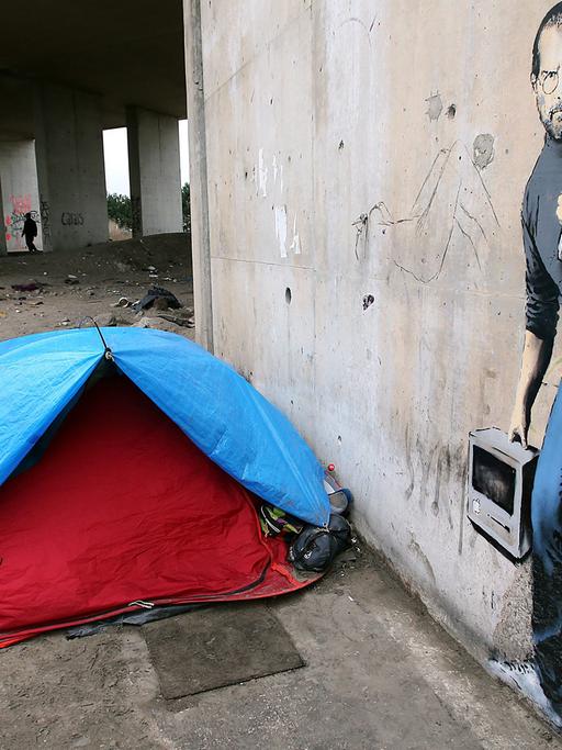Ein dem Streetart-Künstler Banksy zugeschriebenes Bild zeigt den Apple-Gründer Steve Jobs als Flüchtling an einer Wand im illegalen Flüchtlingslager "Jungle" von Calais.