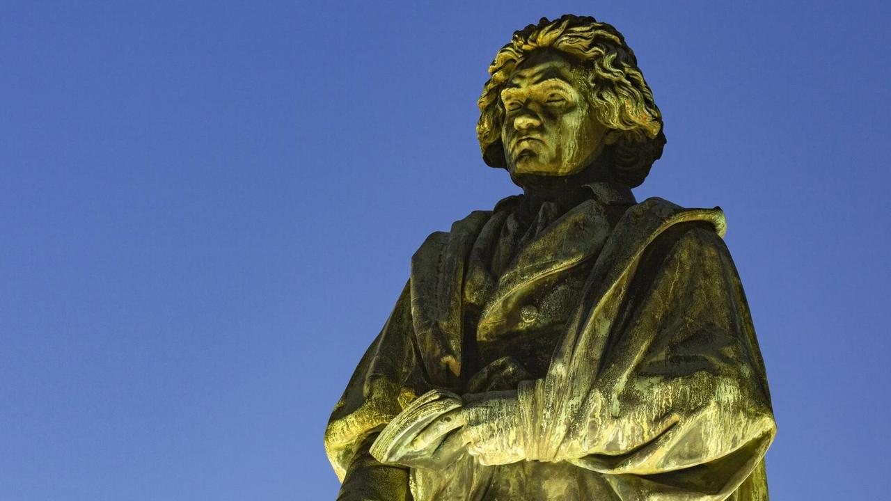 Denkmal am Münsterplatz in Bonn: der Komponist und Pianist Ludwig van Beethoven angestrahlt vor abendlichem Himmel. Denkmal am Münsterplatz in Bonn: der Komponist und Pianist Ludwig van Beethoven angestrahlt vor abendlichem Himmel.