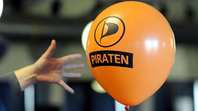 Ein Luftballon mit dem Logo der Piratenpartei fliegt durch den Saal.