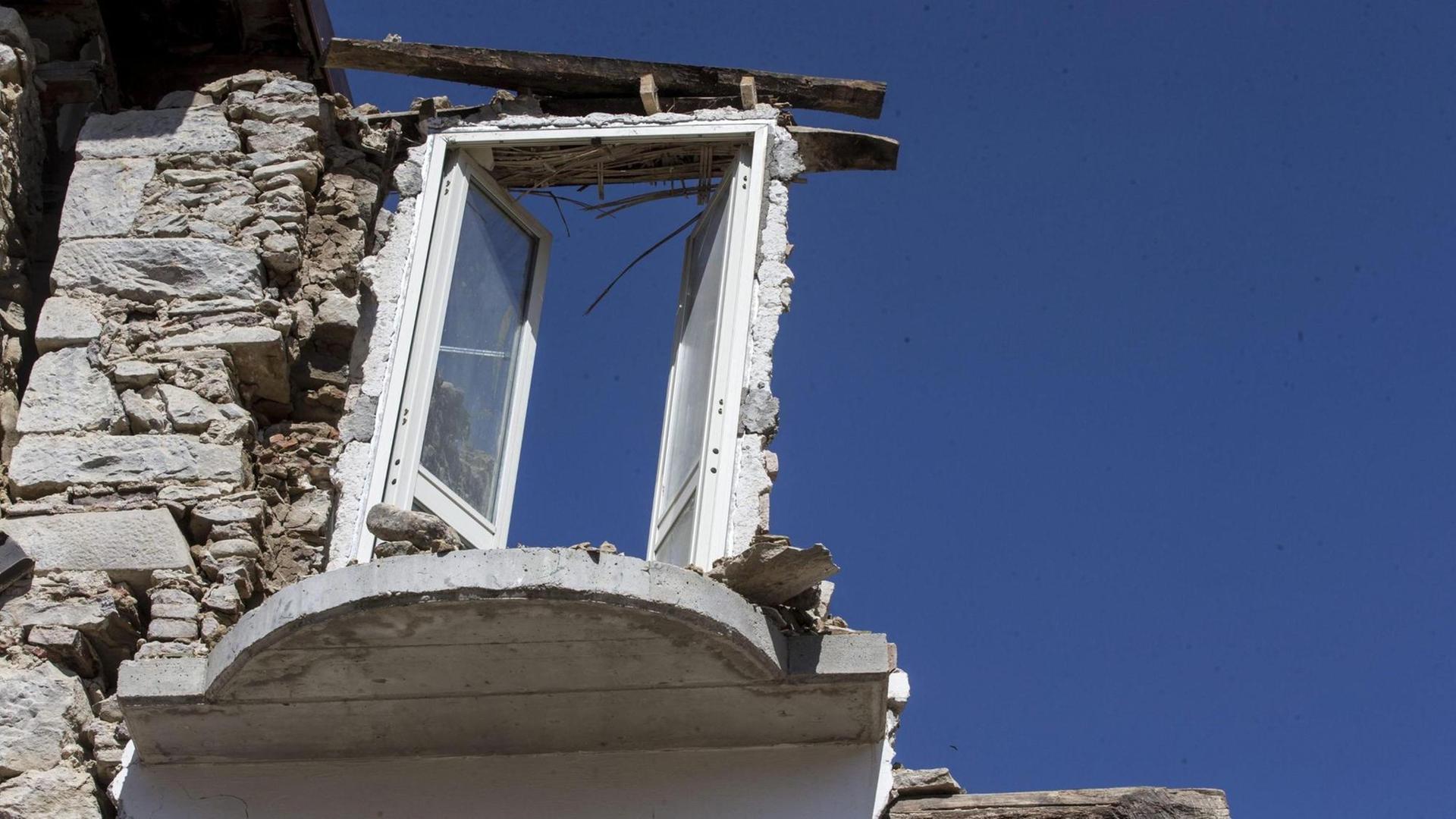 Von einem Haus in Amatrice ist nur noch eine Mauer mit einem Fenster geblieben; das Fenster ist nur noch links und unten von Mauerwerk umgeben. Von einem Haus in Amatrice ist nur noch eine Mauer mit einem Fenster geblieben; das Fenster ist nur noch links und unten von Mauerwerk umgeben.