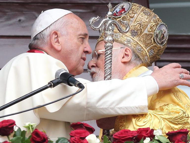 Papst Franziskus und der orthodoxe Patriarch Bartholomäus umarmen sich nach einer gemeinsamen Messe