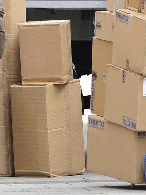 Ein Paketbote sortiert Pakete