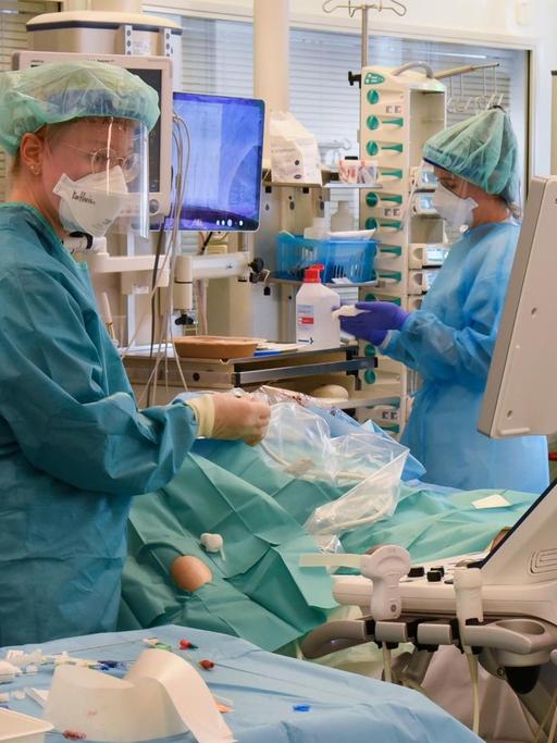 Auf der Covid-Station, einem Bereich der Operativen Intensivstation vom Universitätsklinikum Leipzig, versorgen Ärzte und Intensivpflegekräfte einen Patienten.