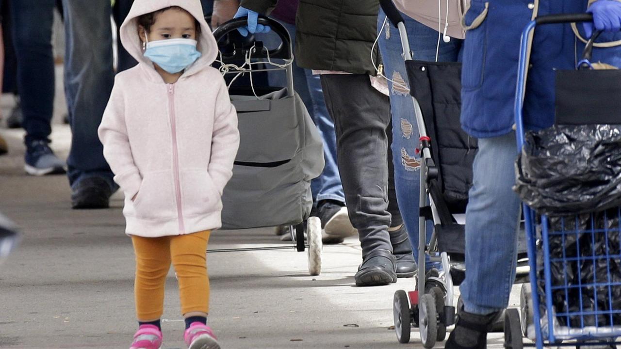 A child wears a protective face mask while adults wait on line for food when U.S. Representative Adriano Espaillat holds a food distribution for neighborhood people struggling financially due to the Coronavirus Pandemic in New York City on Monday, May 18, 2020. The Centers for Disease Control and Prevention have confirmed the link between a rare, potentially deadly syndrome in children resembling Kawasaki s Disease.with COVID-19. New York City s health department has found 145 cases of children were sickened by what was previously referred to as pediatric multi system inflammatory syndrome PIMS-TS and is now referred to as multi-system inflammatory syndrome in children MIS-C. PUBLICATIONxINxGERxSUIxAUTxHUNxONLY NYP20200518111 JOHNxANGELILLO A child wears a protective face mask while adults wait on line for food when U.S. Representative Adriano Espaillat holds a food distribution for neighborhood people struggling financially due to the Coronavirus Pandemic in New York City on Monday, May 18, 2020. The Centers for Disease Control and Prevention have confirmed the link between a rare, potentially deadly syndrome in children resembling Kawasaki s Disease.with COVID-19. New York City s health department has found 145 cases of children were sickened by what was previously referred to as pediatric multi system inflammatory syndrome PIMS-TS and is now referred to as multi-system inflammatory syndrome in children MIS-C. PUBLICATIONxINxGERxSUIxAUTxHUNxONLY NYP20200518111 JOHNxANGELILLO