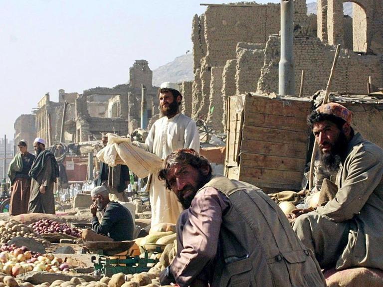 Das Archivbild vom 20.11.2001 zeigt einen Gemüseverkäufer auf einem Basar in Kabul. Auf den Märkten gibt es alles, Kinder fahren Gemüse und Obst auf Karren durch die ganze Stadt, doch es ist einfach zu teuer, damit es die Afghani kaufen. Berge von Schutt säumen die Straßenzüge. (zu dpa Korr-Bericht "Wir würden gerne hoffen - Kampf ums Überleben prägt Leben in Kabul).