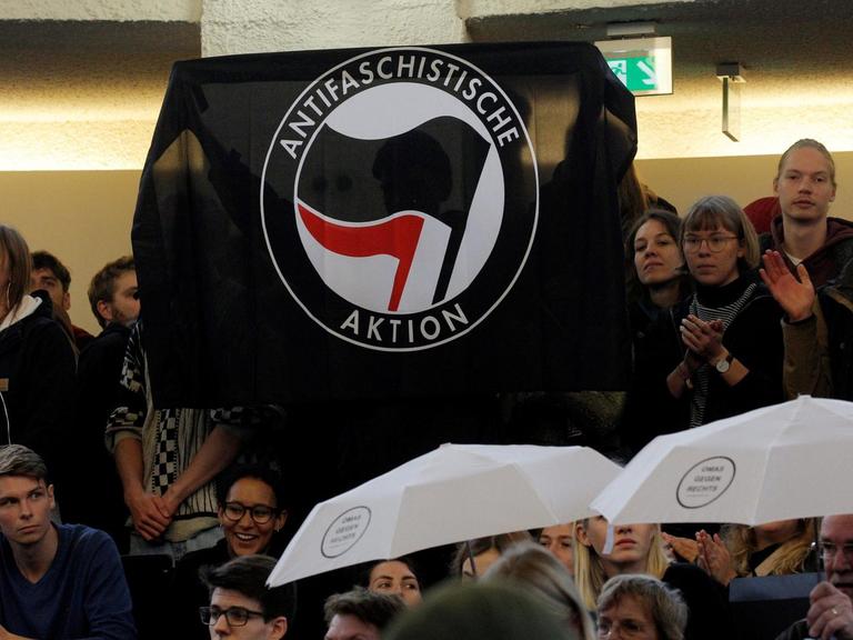 Menschen demonstrieren in einem Hörsaal der Universität Hamburg, während der Wirtschaftswissenschaftler und AfD-Mitbegründer Lucke versucht, seine Antritts-Vorlesung zu halten.