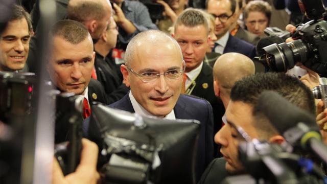 Michail Chodorkowski kommt am 22.12.2013 ins «Mauermuseum am Checkpoint Charlie» in Berlin und bahnt sich den Weg durch die wartenden Journalisten.