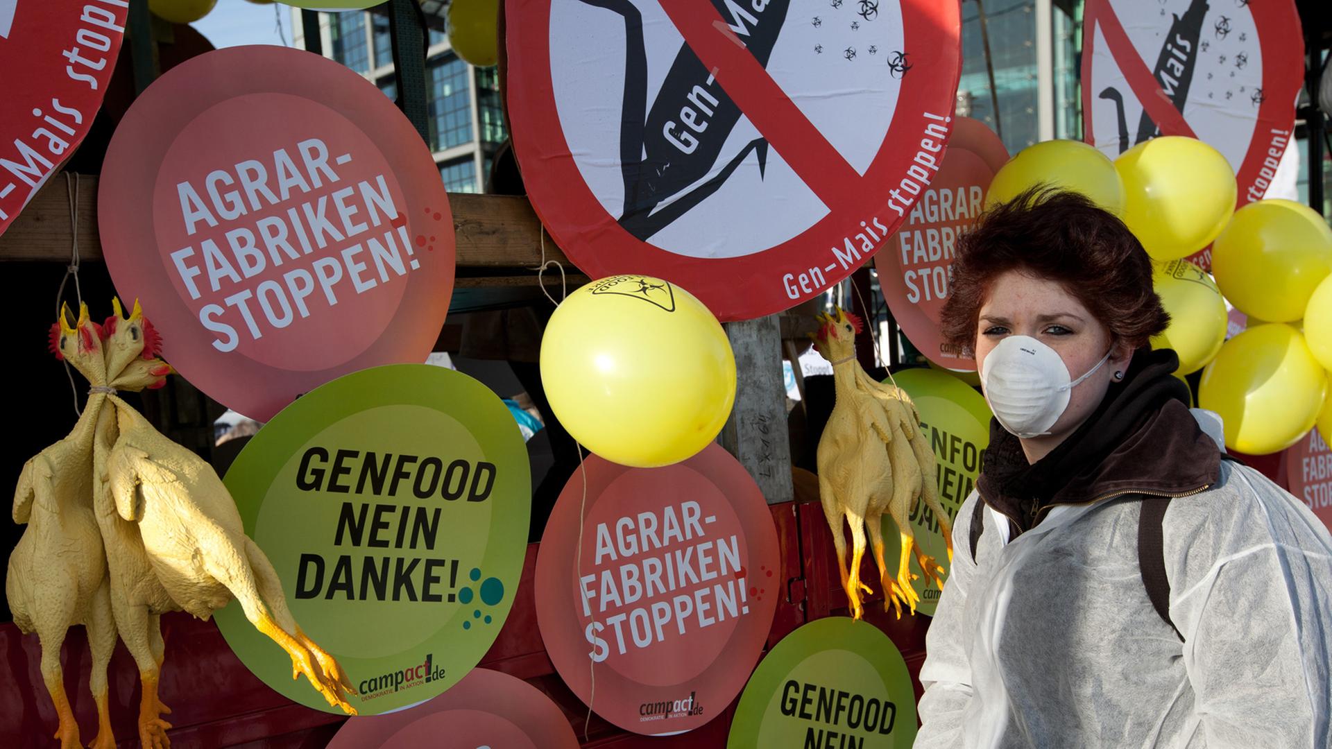 Eine maskierte Demonstrantin protestiert gegen Gen-Food in Berlin. Eine maskierte Demonstrantin protestiert gegen Gen-Food in Berlin.